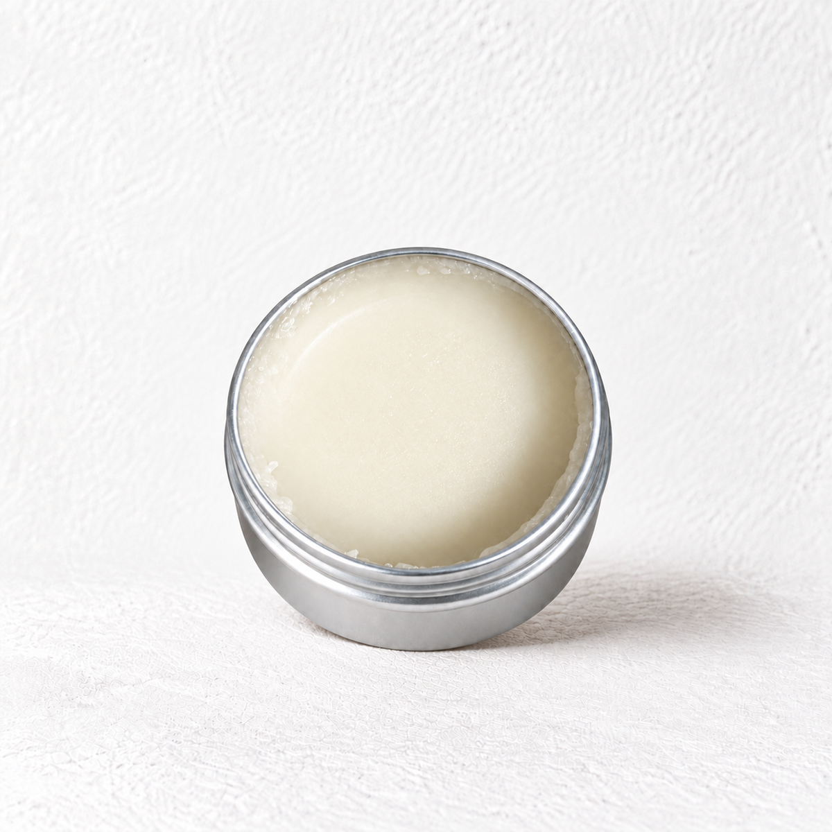 The Prudent Shepherd fragrance-free barrier balm in an open 2 oz silver tin