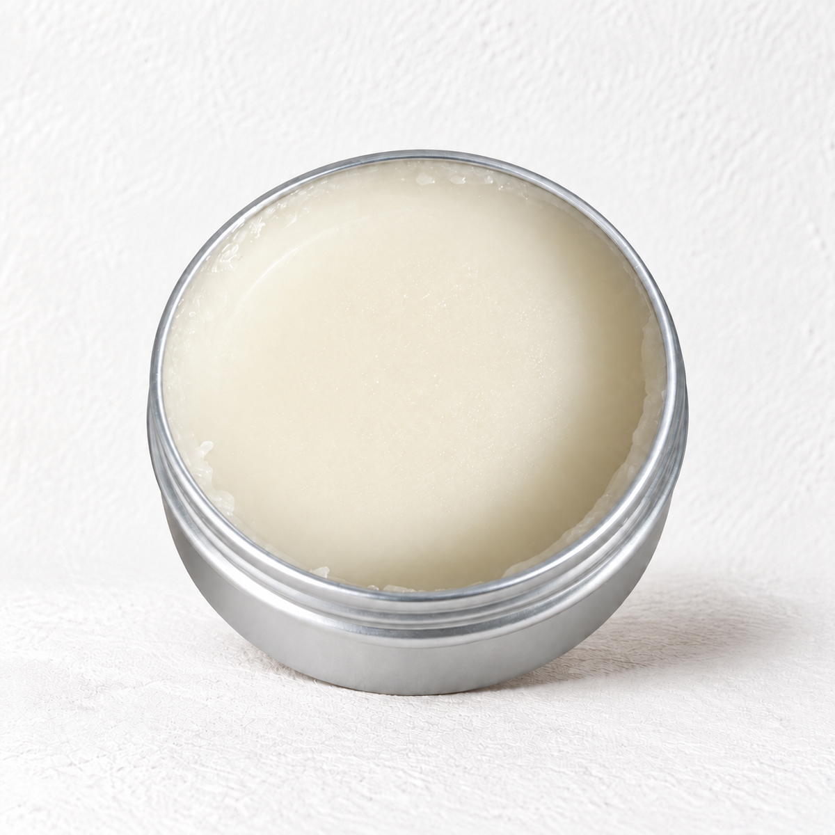 The Prudent Shepherd fragrance-free barrier balm in an open 4 oz silver tin.